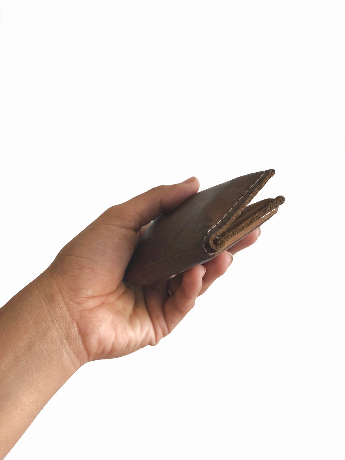 Brown small bifold handcrafted wallet. Each side holds 10 cards. We love putting folded bills on one side and cards on the other.