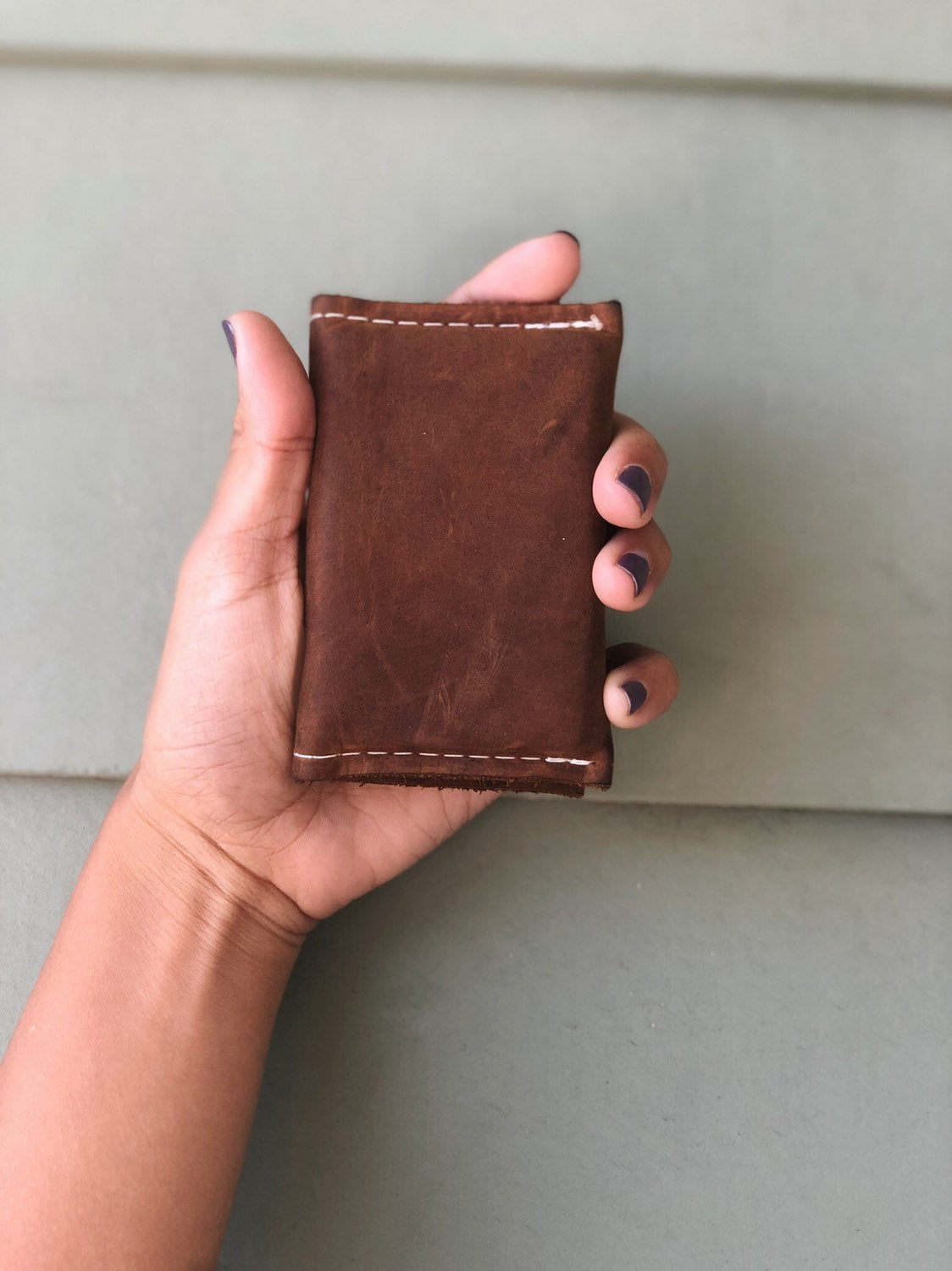 Brown small bifold handcrafted wallet. Each side holds 10 cards. We love putting folded bills on one side and cards on the other.