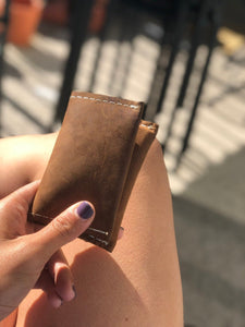 Brown small bifold handcrafted wallet. Each side holds 10 cards. We love putting folded bills on one side and cards on the other.