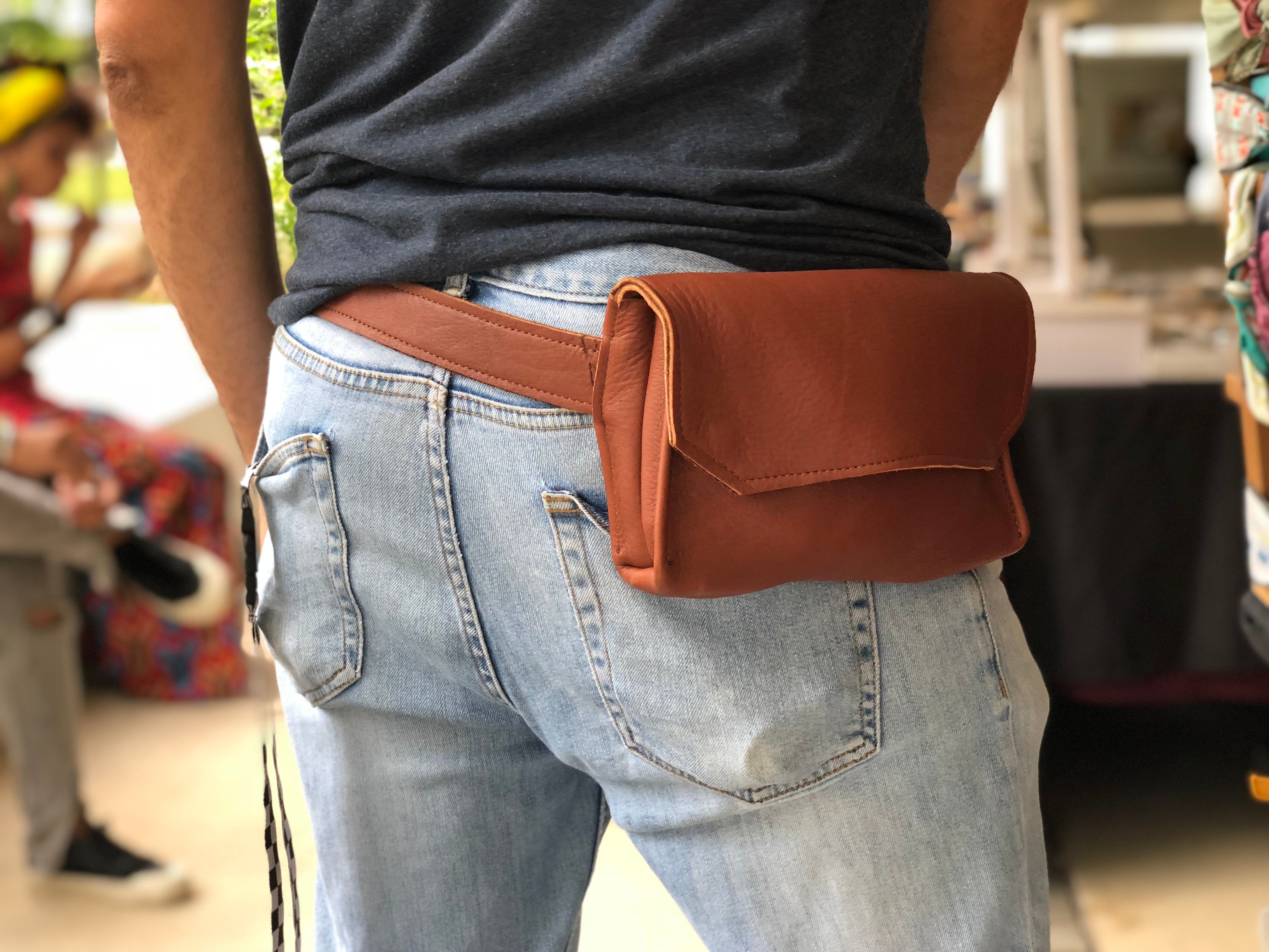 Brown handmade genuine leather fanny pack (hipsack), can be used as a cross-body bag. Hand-crafted in Puerto Rico. Oduardo is a husband and wife leather goods handmade small-batch fair trade shop. We make all our products by hand. In our shop you can find convertible messenger bags, leather backpacks, leather briefcases, leather cross-body bags, leather passport covers, leather wallets, leather bifold wallets, and more!