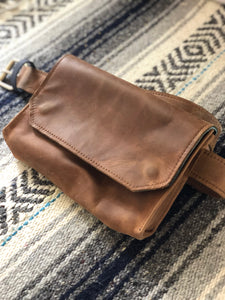 Brown handmade genuine leather fanny pack (hipsack), can be used as a cross-body bag. Hand-crafted in Puerto Rico. Oduardo is a husband and wife leather goods handmade small-batch fair trade shop. We make all our products by hand. In our shop you can find convertible messenger bags, leather backpacks, leather briefcases, leather cross-body bags, leather passport covers, leather wallets, leather bifold wallets, and more!