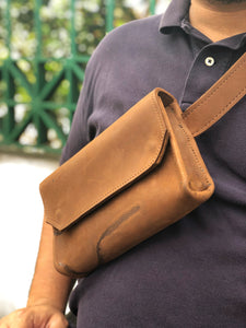 Tan handmade genuine leather fanny pack (hipsack), can be used as a cross-body bag with natural mark. Hand-crafted in Puerto Rico. Oduardo is a husband and wife leather goods handmade small-batch fair trade shop. We make all our products by hand. In our shop you can find convertible messenger bags, leather backpacks, leather briefcases, leather cross-body bags, leather passport covers, leather wallets, leather bifold wallets, and more!