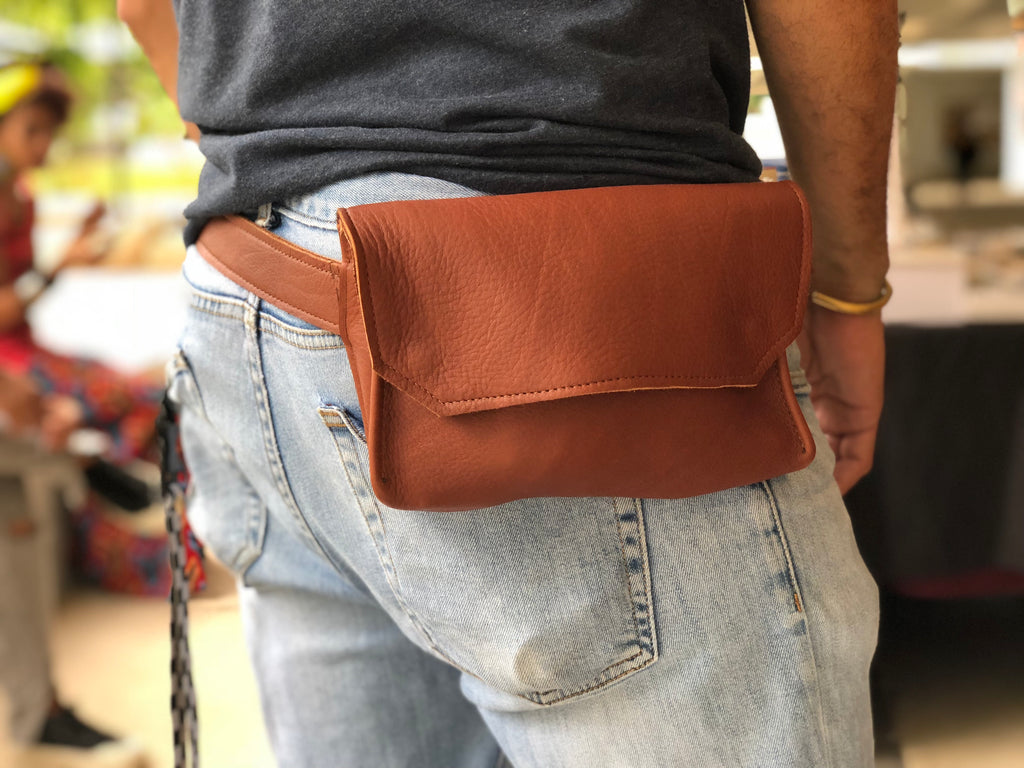 Brown handmade genuine leather fanny pack (hipsack), can be used as a cross-body bag. Hand-crafted in Puerto Rico. Oduardo is a husband and wife leather goods handmade small-batch fair trade shop. We make all our products by hand. In our shop you can find convertible messenger bags, leather backpacks, leather briefcases, leather cross-body bags, leather passport covers, leather wallets, leather bifold wallets, and more!