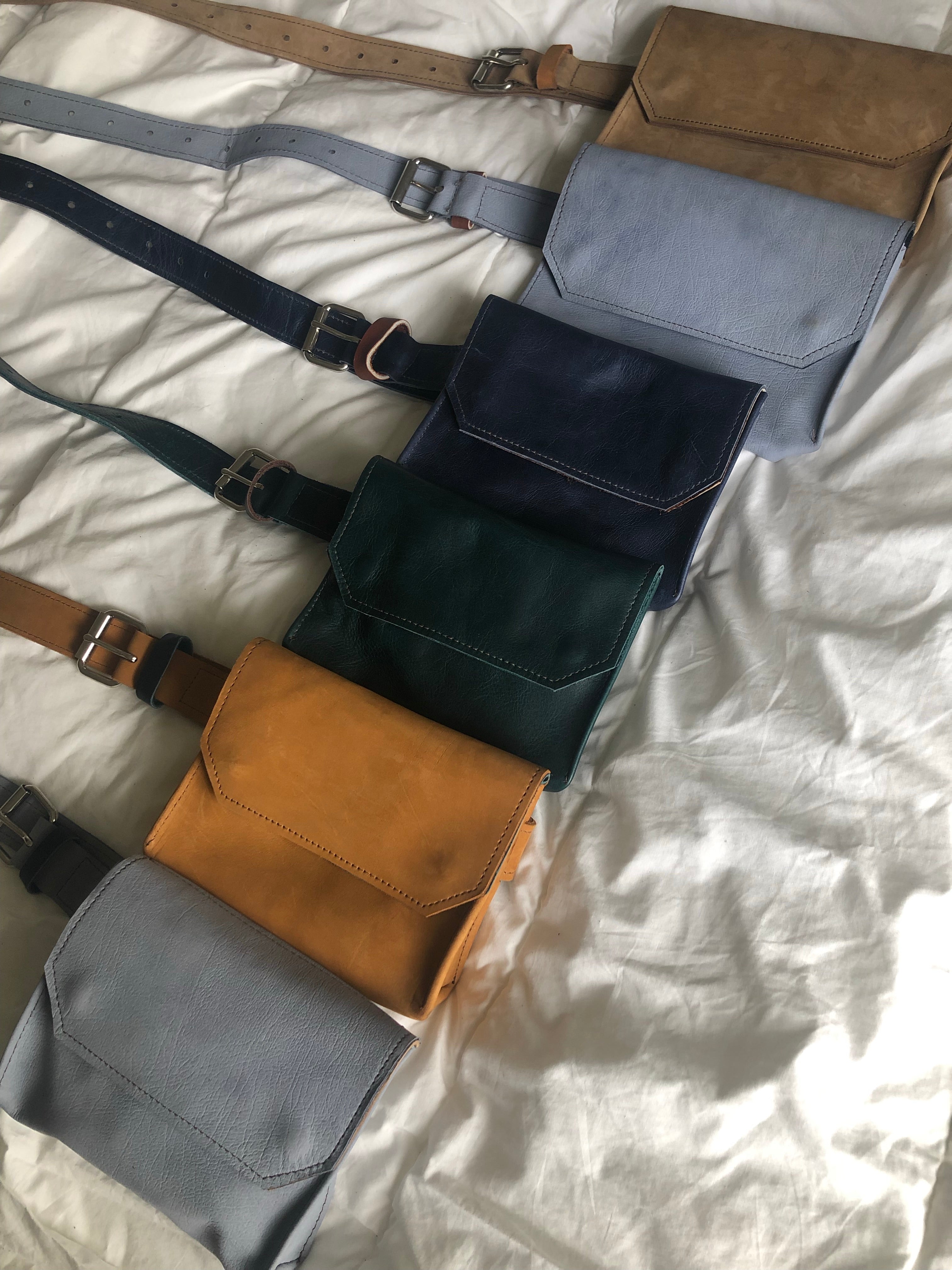Beige, gray, blue, green and tan handmade genuine leather fanny pack (hipsack), can be used as a cross-body bag. Hand-crafted in Puerto Rico. Oduardo is a husband and wife leather goods handmade small-batch fair trade shop. We make all our products by hand. In our shop you can find convertible messenger bags, leather backpacks, leather briefcases, leather cross-body bags, leather passport covers, leather wallets, leather bifold wallets, and more!