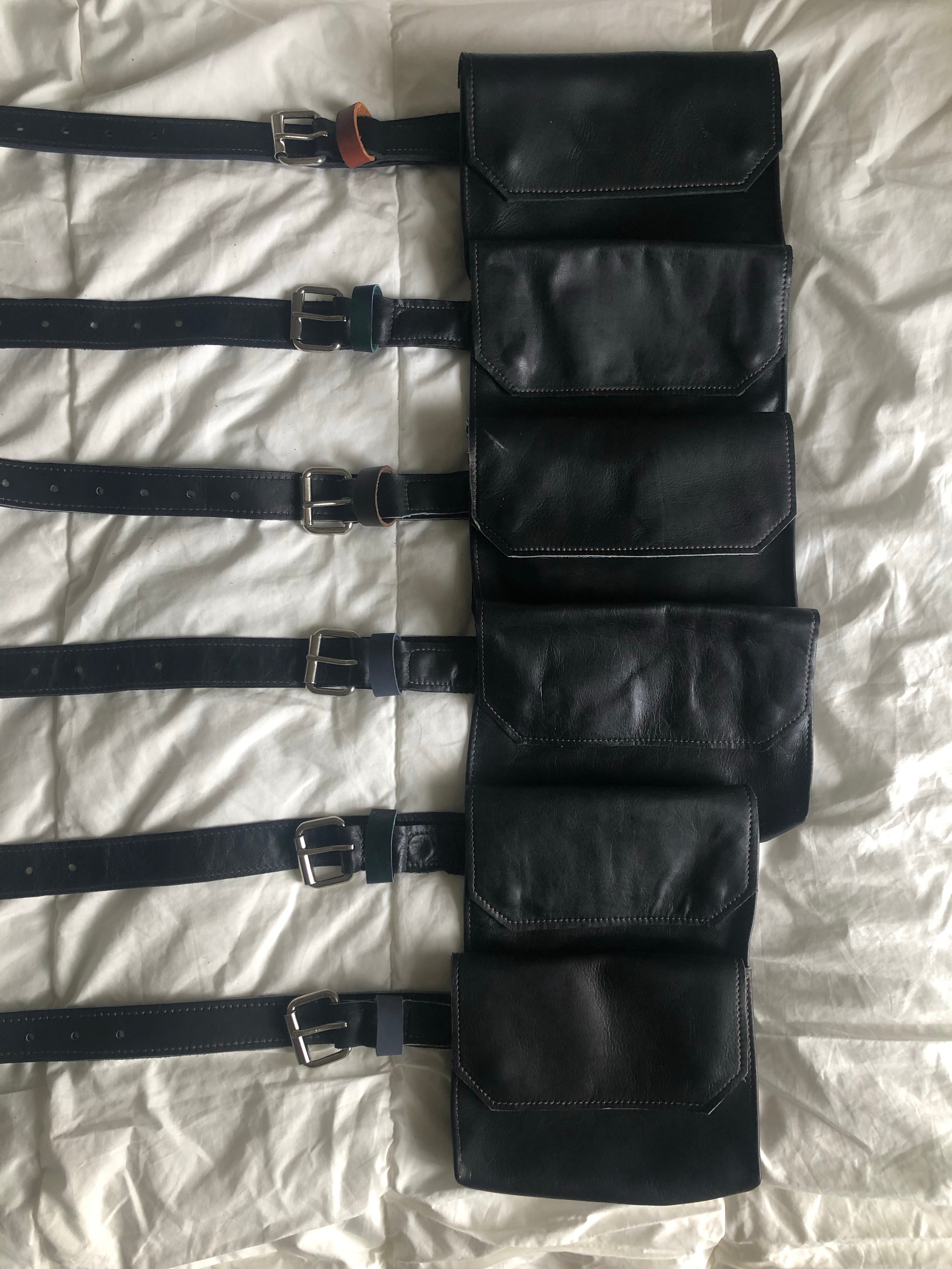 Multiple black handmade genuine leather fanny pack (hipsack), can be used as a cross-body bag. Hand-crafted in Puerto Rico. Oduardo is a husband and wife leather goods handmade small-batch fair trade shop. We make all our products by hand. In our shop you can find convertible messenger bags, leather backpacks, leather briefcases, leather cross-body bags, leather passport covers, leather wallets, leather bifold wallets, and more!
