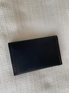 Black small bifold handcrafted wallet. Each side holds 10 cards. We love putting folded bills on one side and cards on the other.